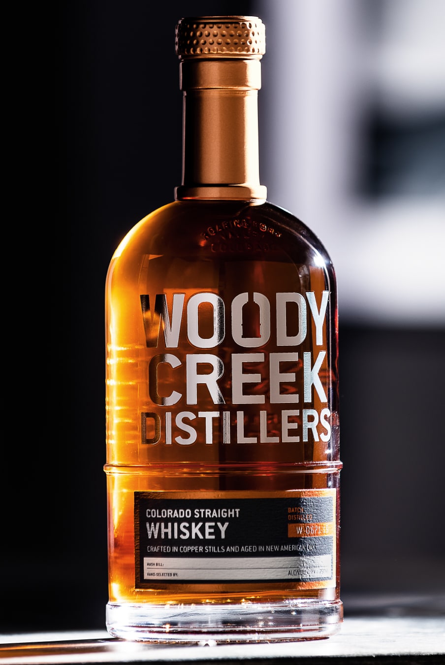 Woody Creek Distillers Whiskey bottle in sunlight